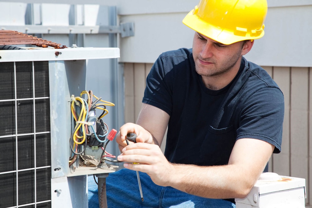 Staunton HVAC contractor working on an outside unit.